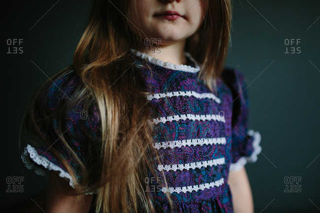 Little girl in a blue and purple paisley dress