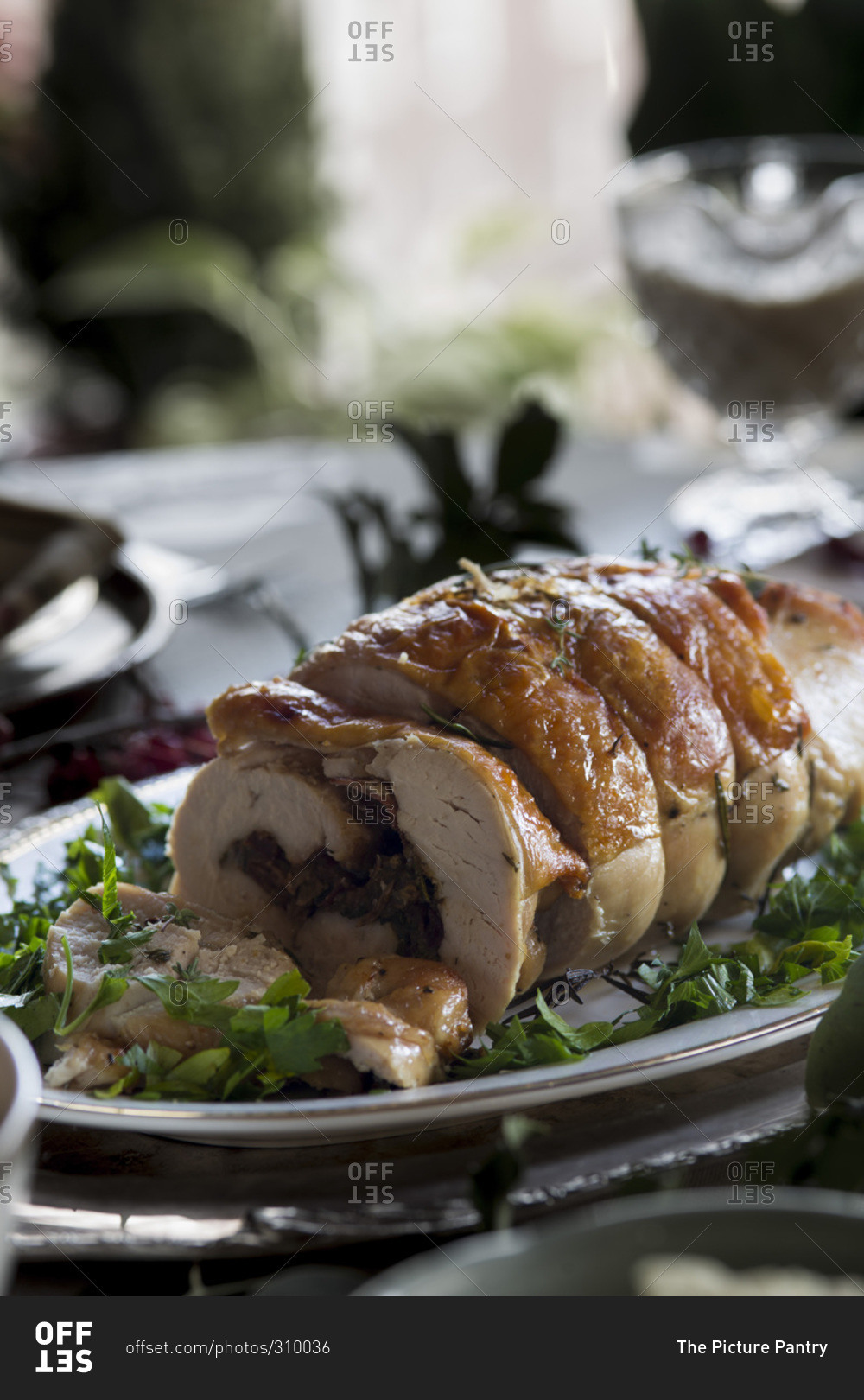Stuffed turkey breast on platter on Thanksgiving table