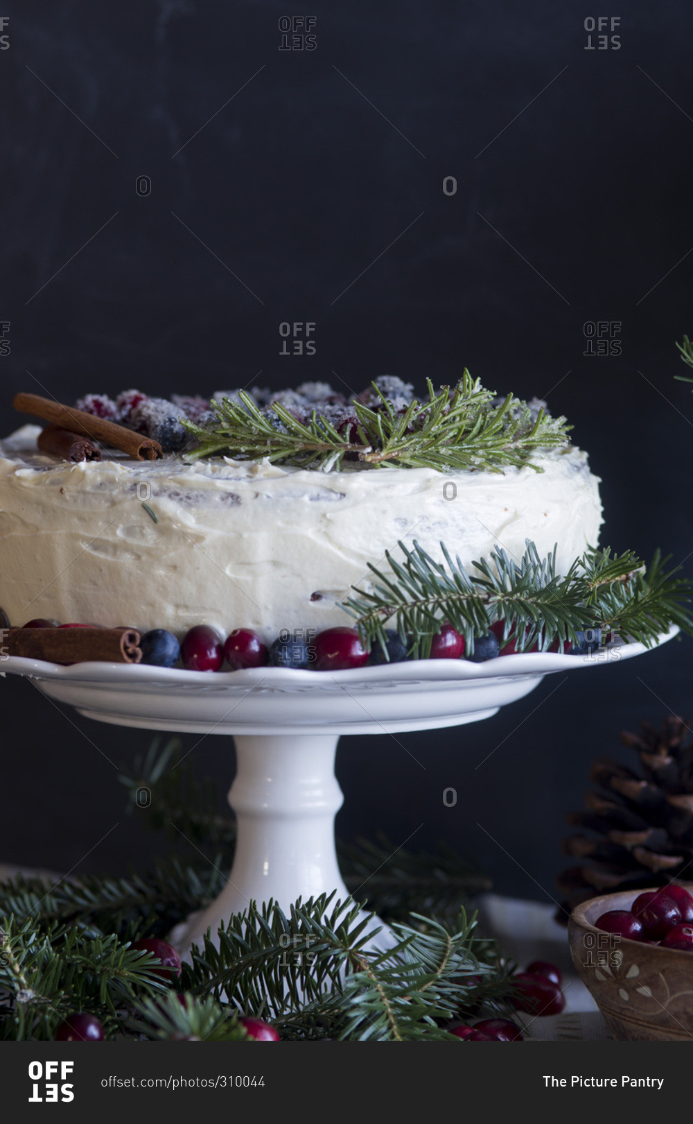 Christmas Cake Decorated With Berries Cinnamon And Evergreen