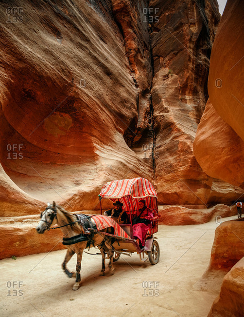 Petra, Jordan - November, 2010: Horse drawn carriage going through the Siq in Petra, Jordan