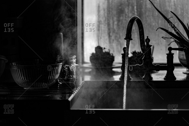 Steaming Water Pouring Out Of The Kitchen Faucet Stock Photo Offset