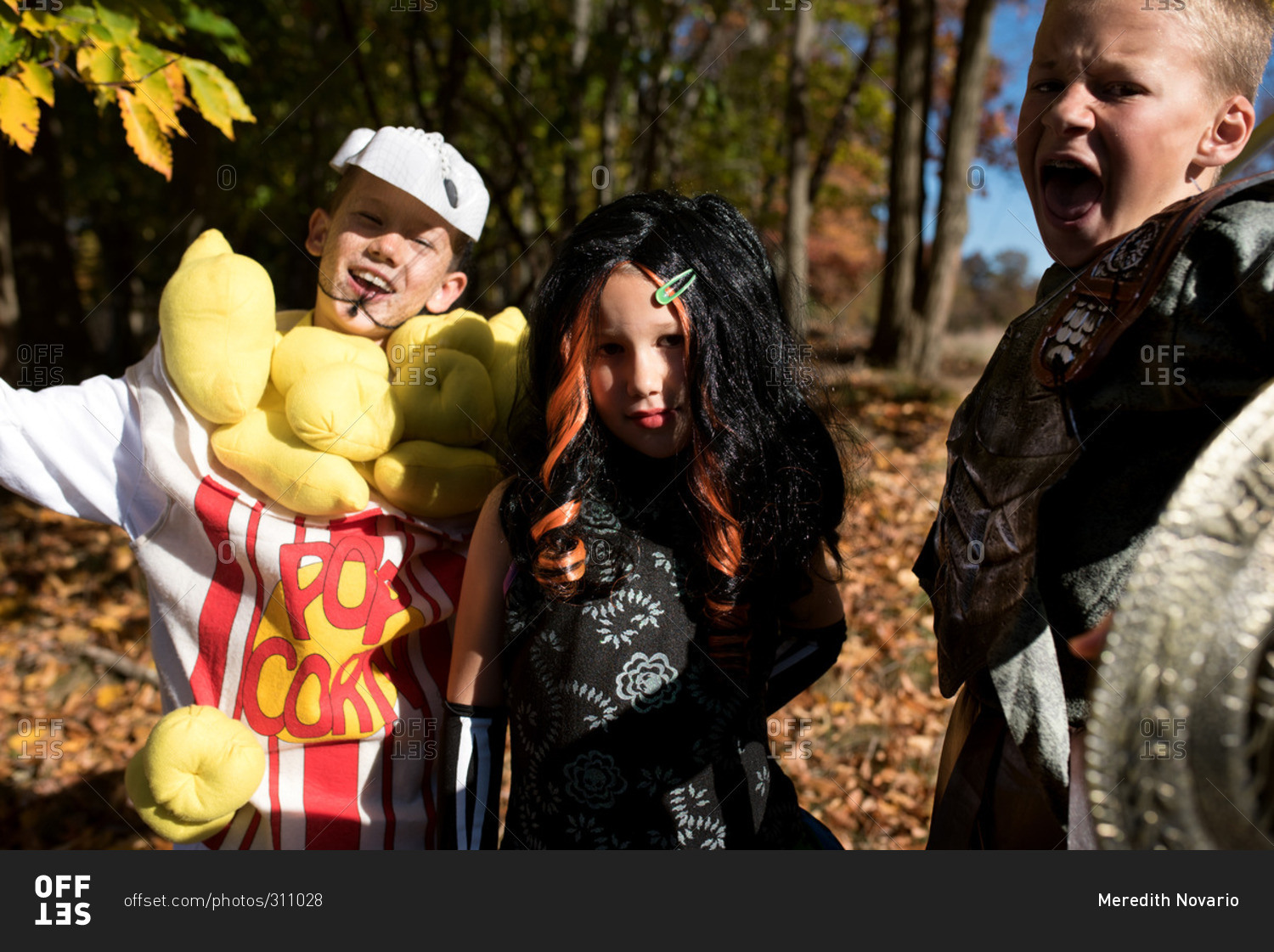 Three children in Halloween costumes