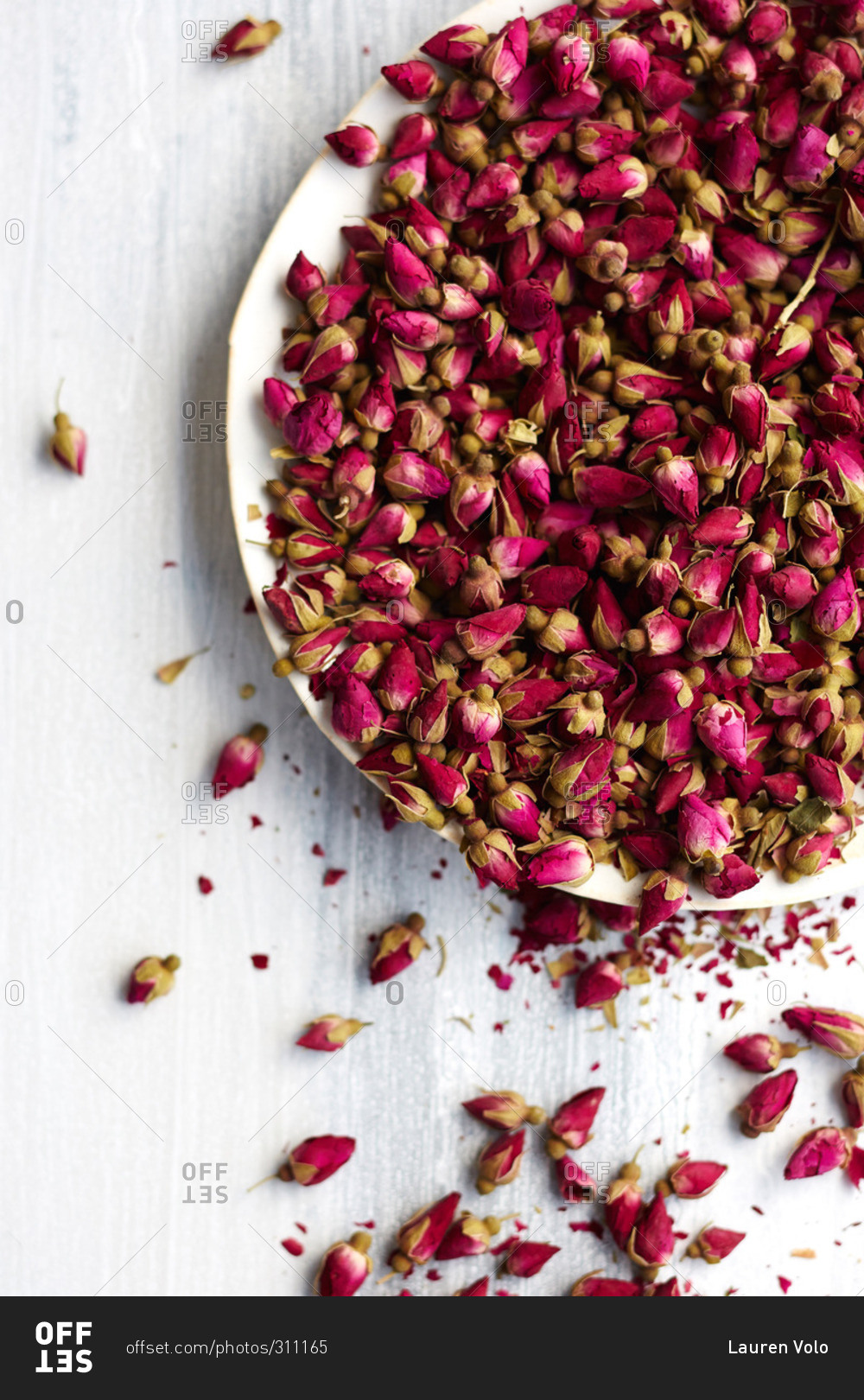 Bowl of small rose buds used as an ingredient in a cake