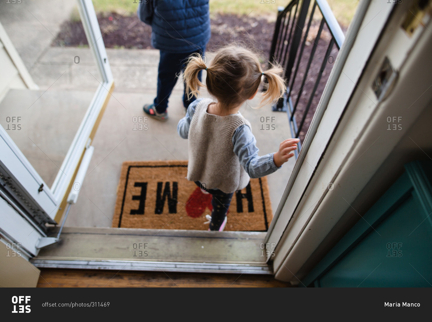 children-walking-out-the-front-door-stock-photo-offset