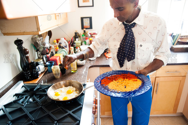 New York City - August 21, 2012: Marcus Samuelson preparing breakfast at home