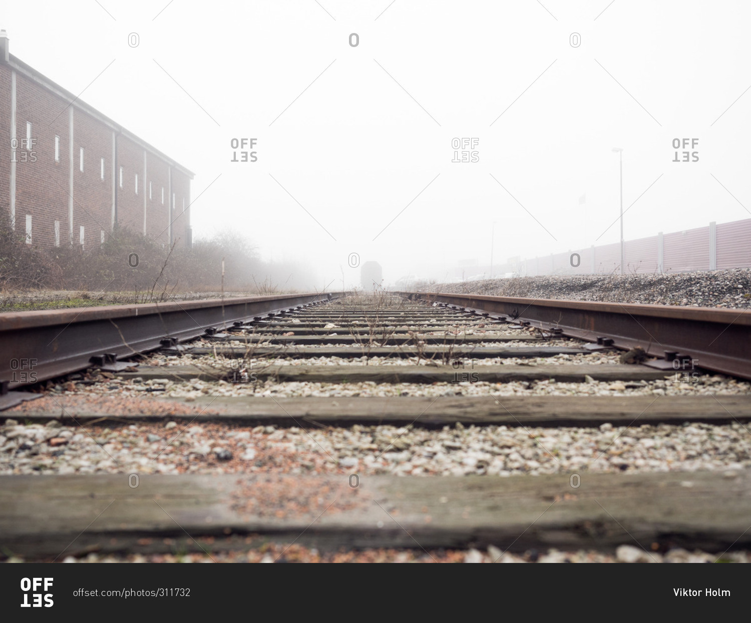 Low angle view of train tracks on a misty day