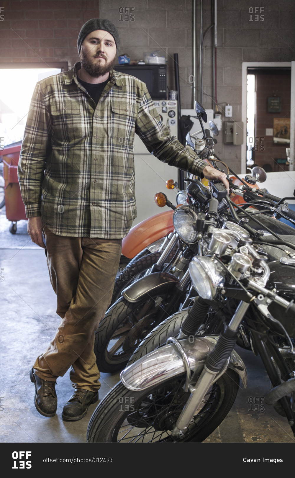 Portrait of a mechanic in a shop with motorcycles