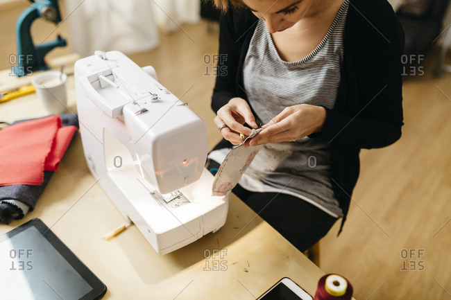 Young fashion designer checking a seam