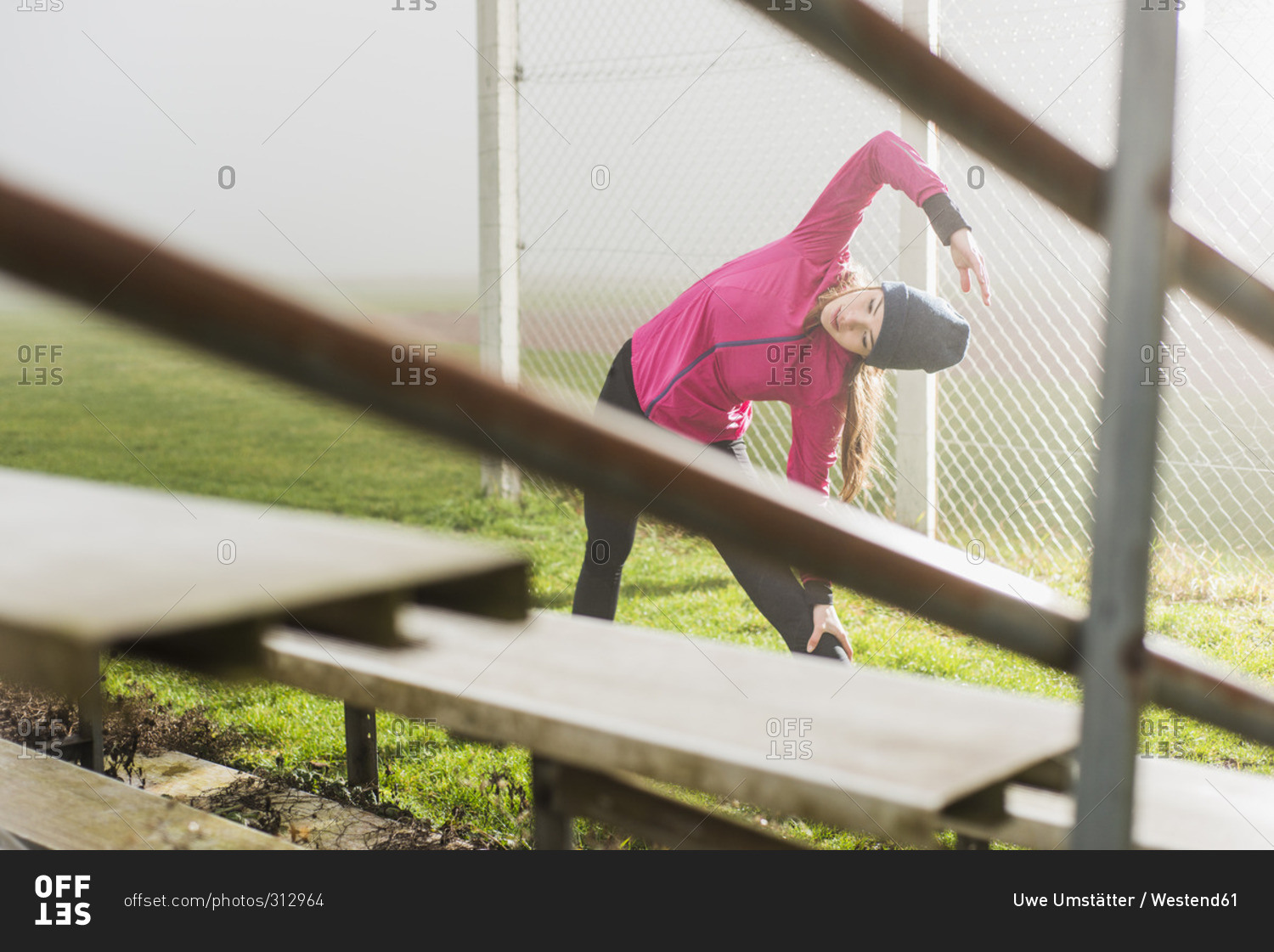 Young woman doing workout on a sports field