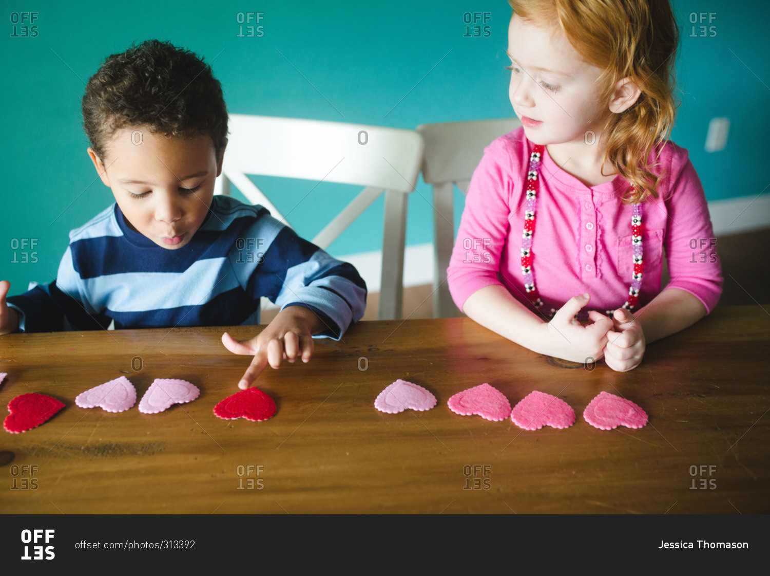 Two children making a Valentine's Day craft