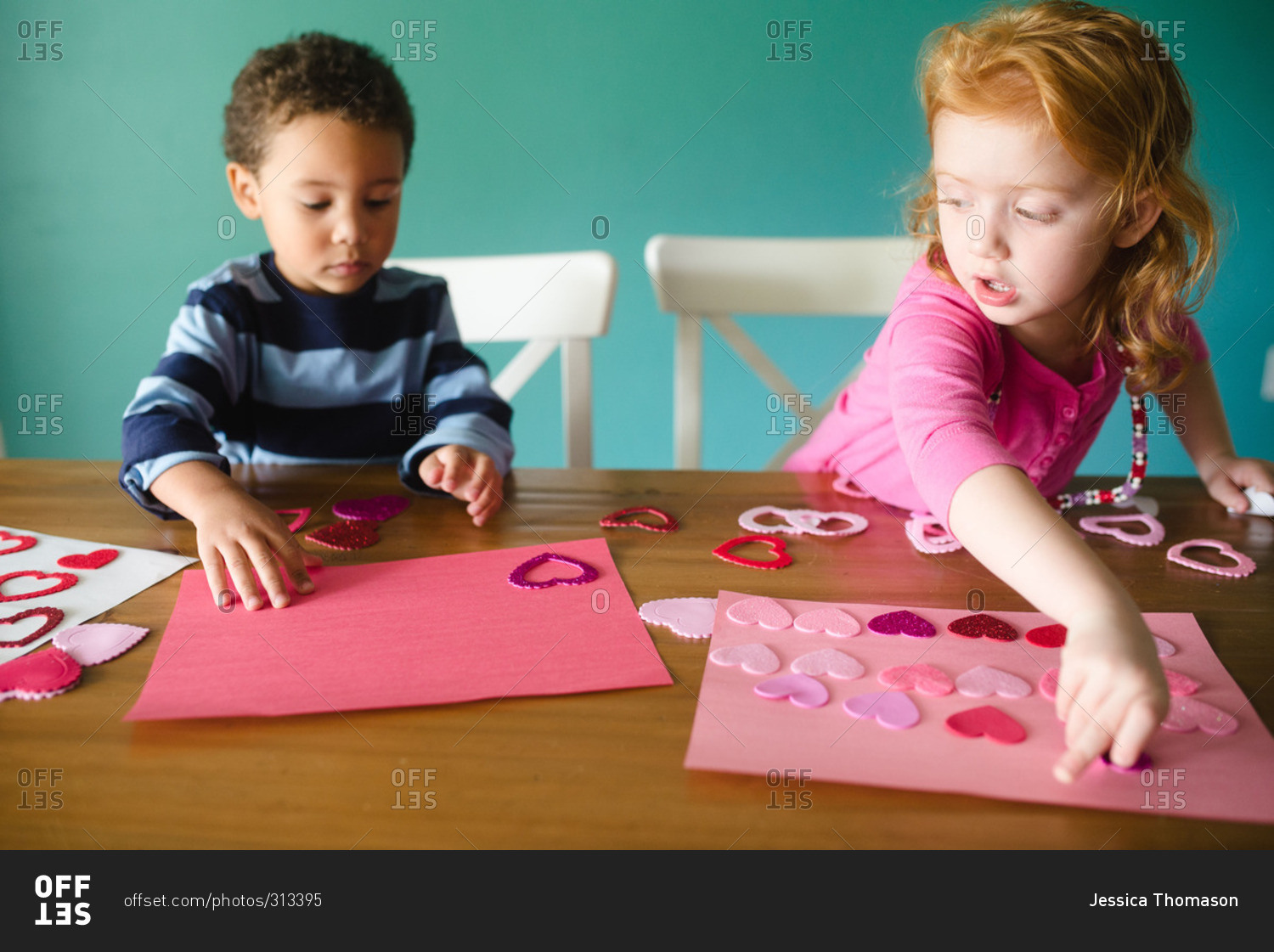Two kids making a Valentine's Day craft