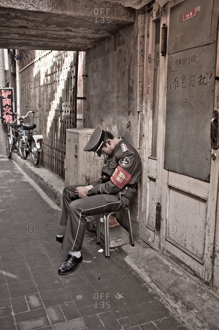 Chinese man in uniform asleep
