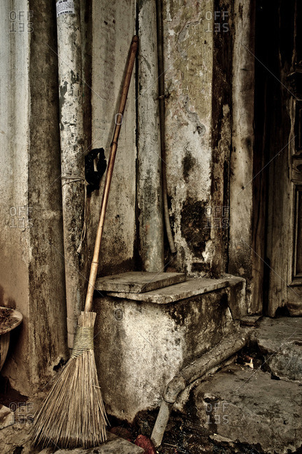 Broom outside derelict building, Vietnam