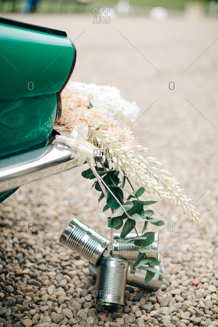 Wedding Decoration Of Tin Cans And Flowers Behind A Car For A