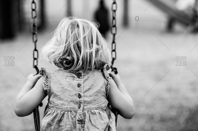 Little girl on a swing in black and white