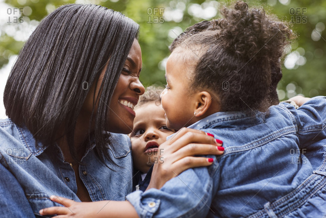 Mother leaning close to her young daughter and smiling