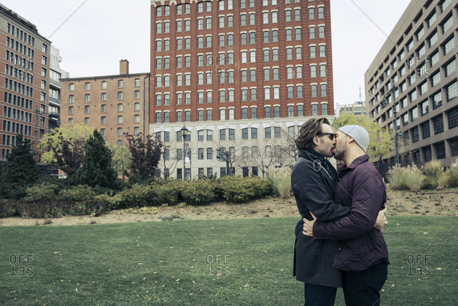 Couple share a kiss in Lower Manhattan park