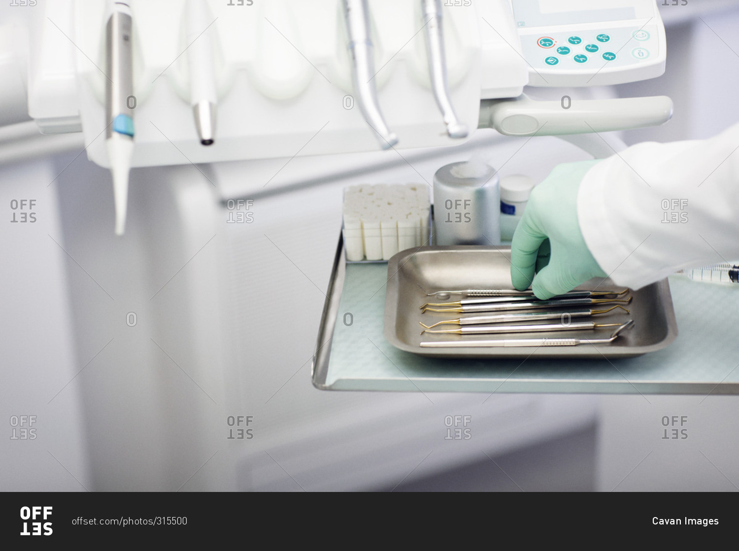 Dentist selecting a dental instrument