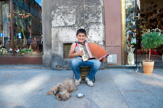 Krakow, Poland - May 26, 2011: Boy playing an accordion in Old Town, Krakow, Poland