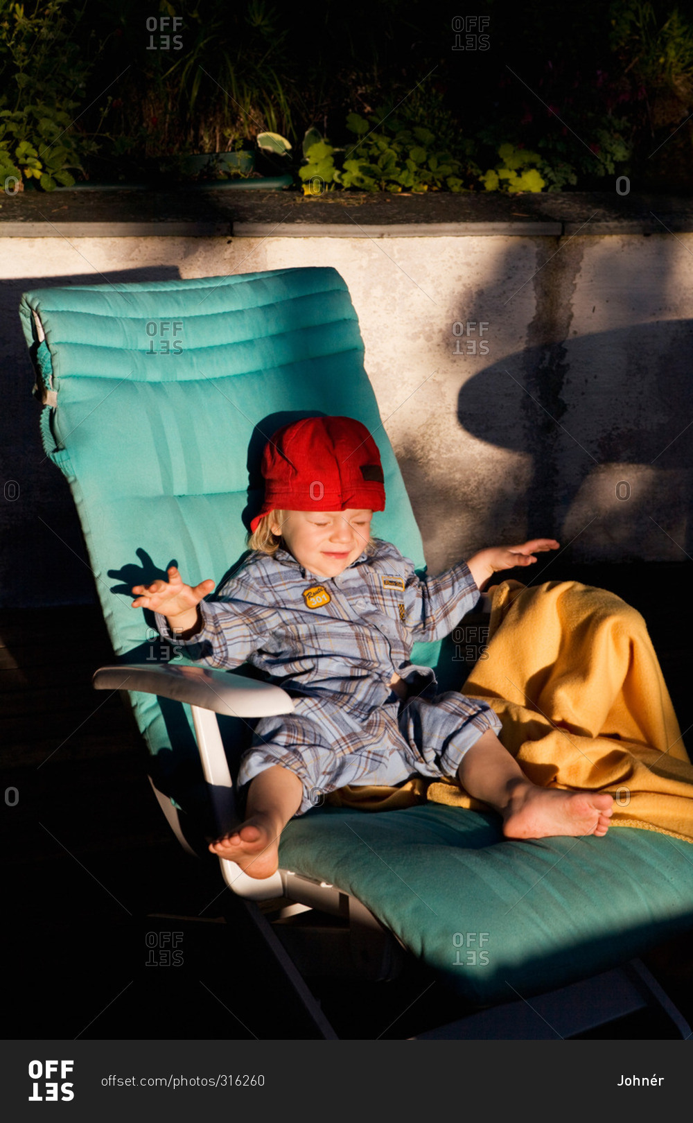 Boy in a lounger blinded by the sun