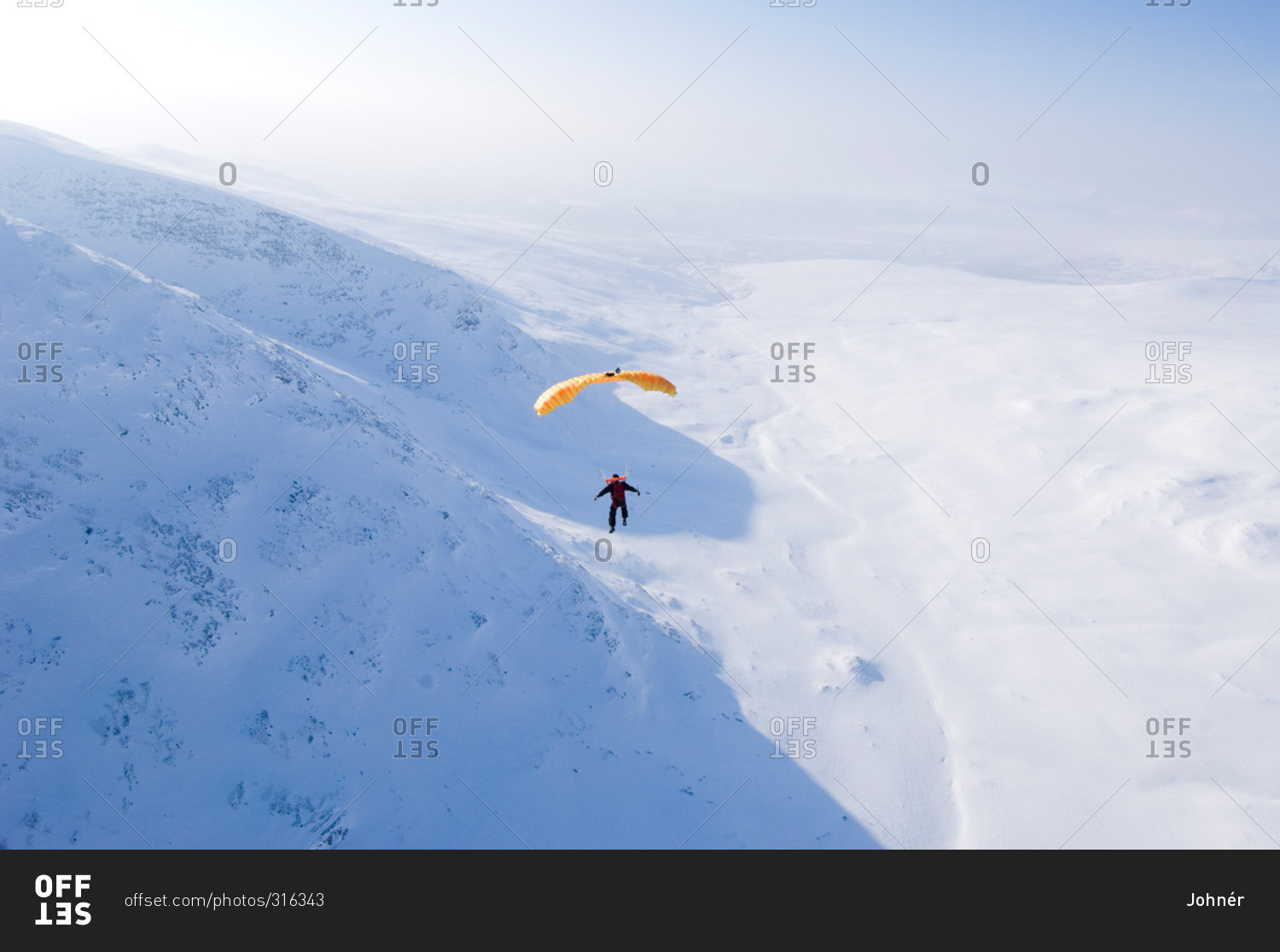 Parachute jumper against a mountain scenery, Sweden stock photo OFFSET
