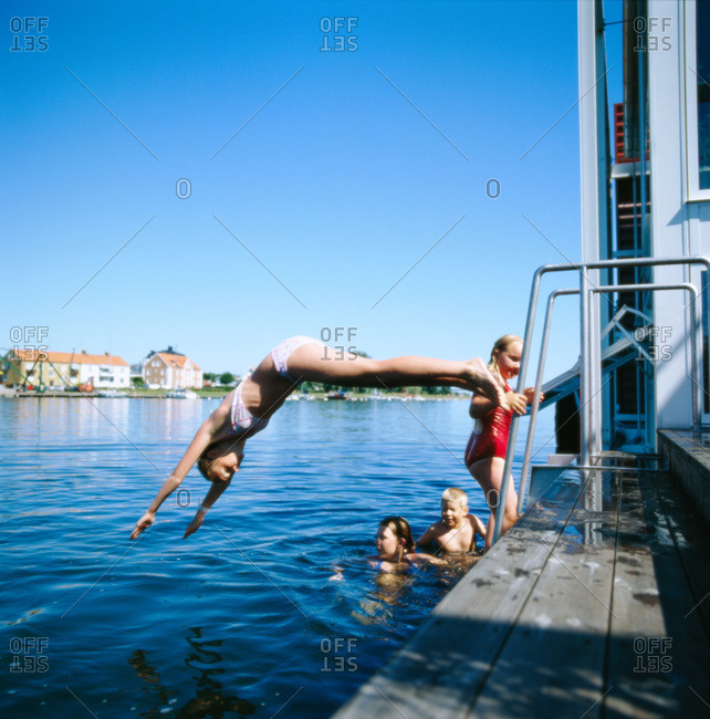 Children swimming at a jetty