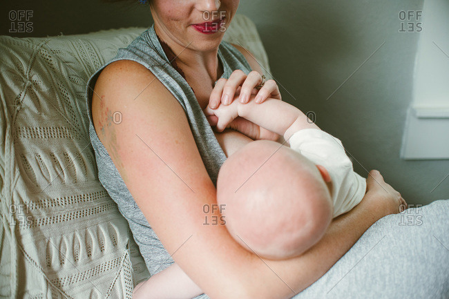 Woman sitting in bed breastfeeding