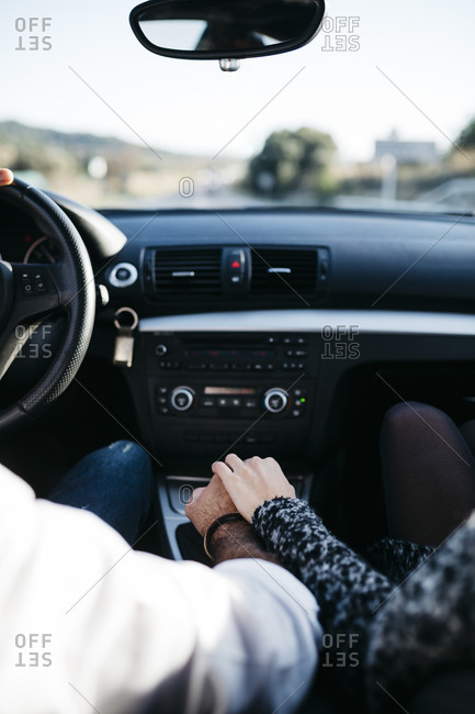 Couple holding hands in a car