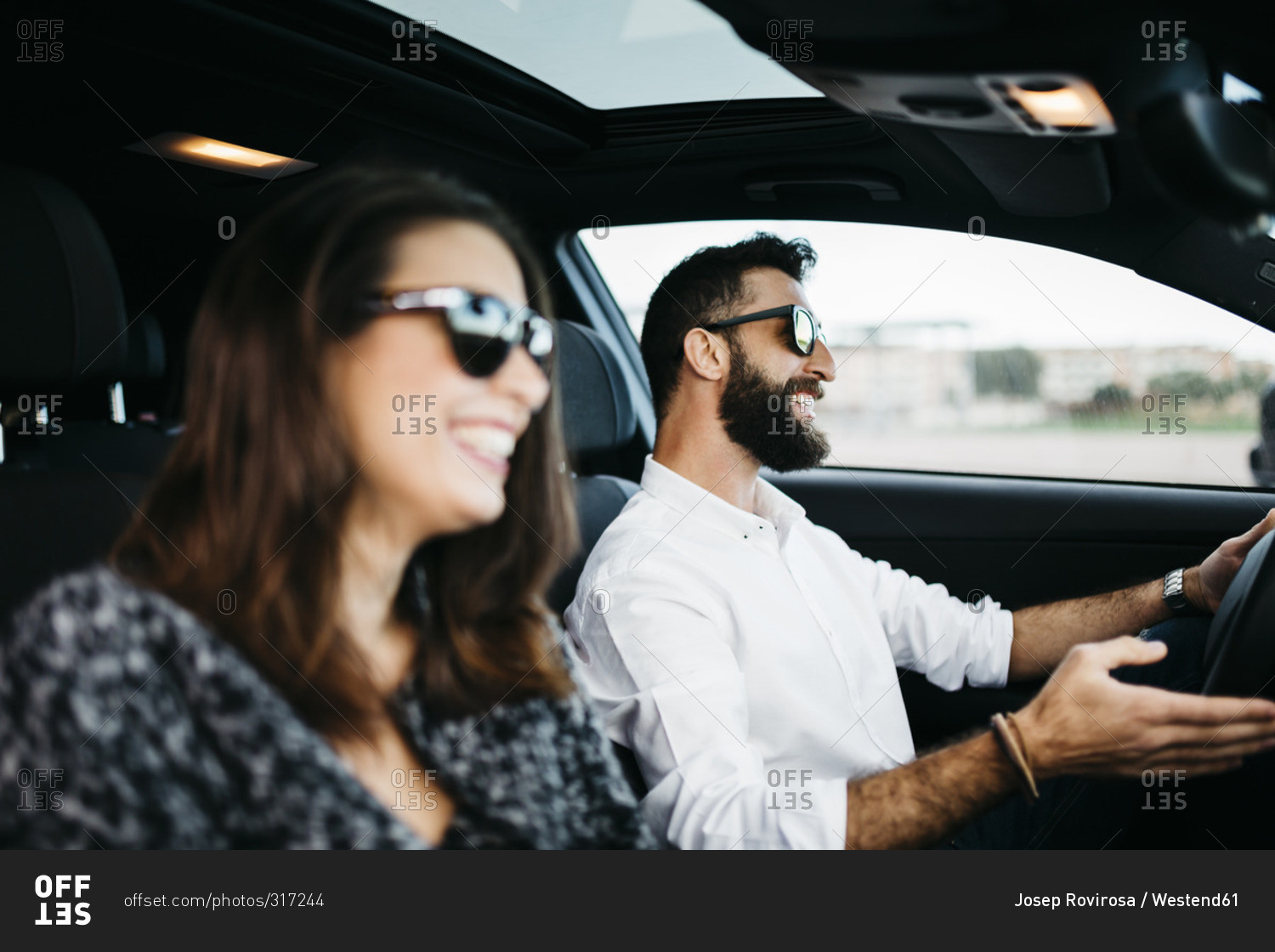 Young couple driving in a car