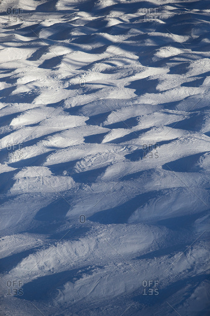 Mounds of snow covered in ski tracks