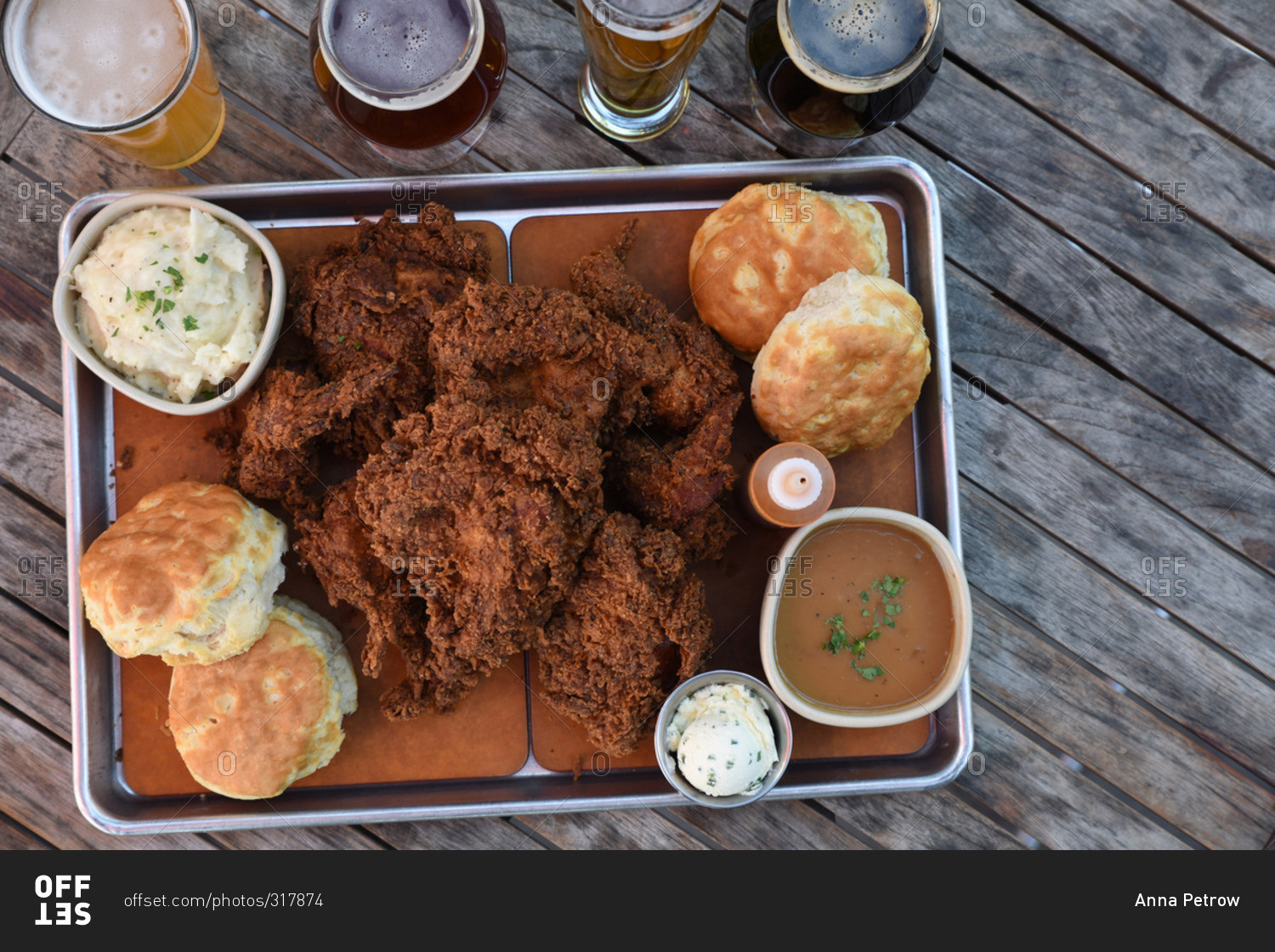 Tray of fried chicken and biscuits served with a flight of beer