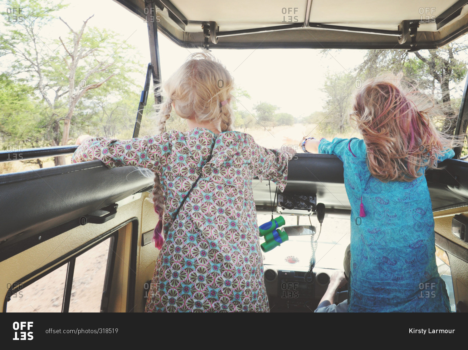 Girls riding through a safari in rural Africa