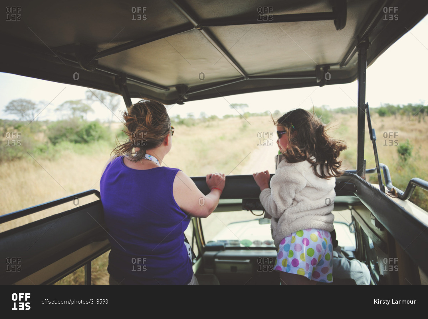 Mother with her daughter on safari in the African Serengeti