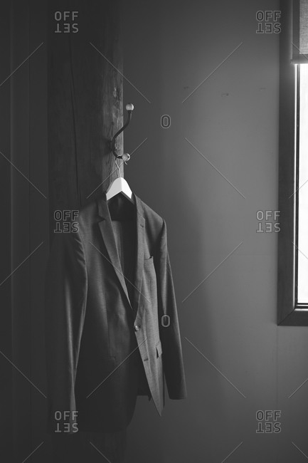 A  suit hanging by a window