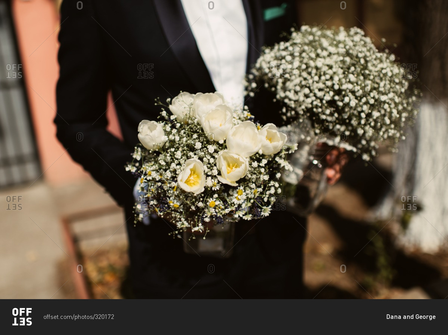 Groom holding bridal bouquets