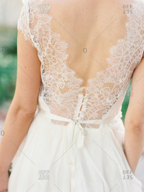 Delicate lace on the back of a bride's dress stock photo - OFFSET