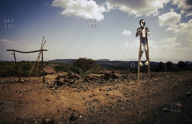 Omo Valley, Southern Ethiopia - December 7, 2010: Boy performing on stilts, Ethiopia