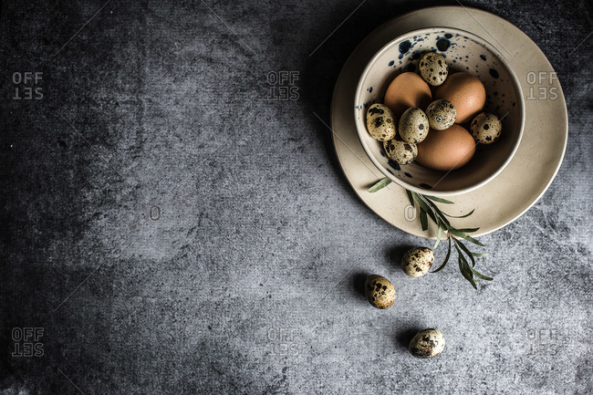 Overhead view of a bowl of quail eggs on a table
