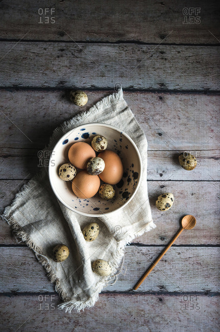 Overhead view of a bowl of quail eggs on a table