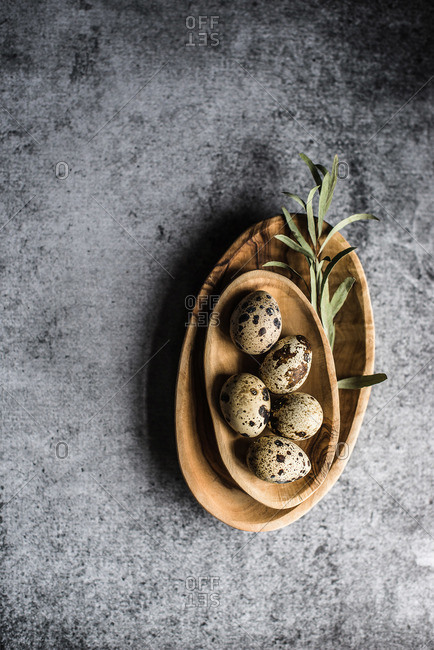 Overhead view of a bowl of quail eggs on a table