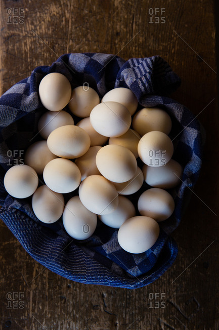 Overhead view of a eggs in a linen covered basket