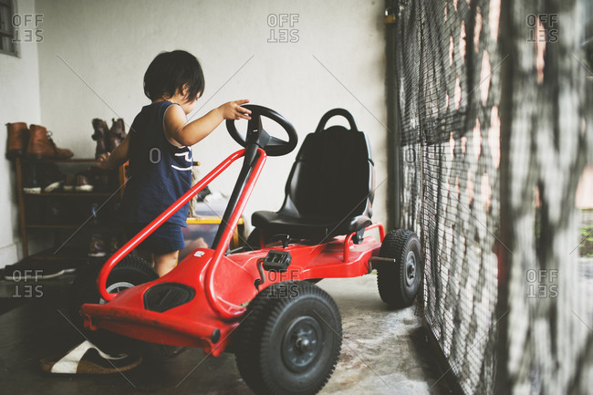 Little boy by a go cart