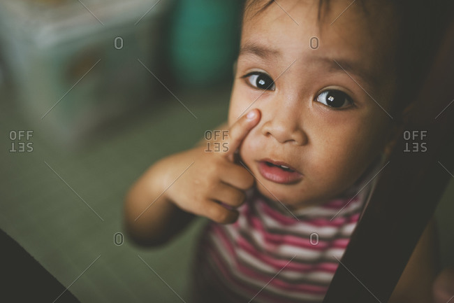 Close up of boy touching his face
