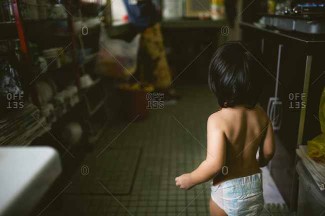 Boy in underwear standing in home