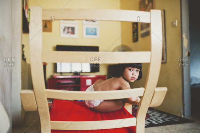 Boy sitting in a chair at home