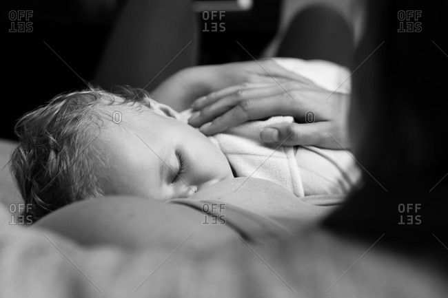 Mother breastfeeding baby in black and white