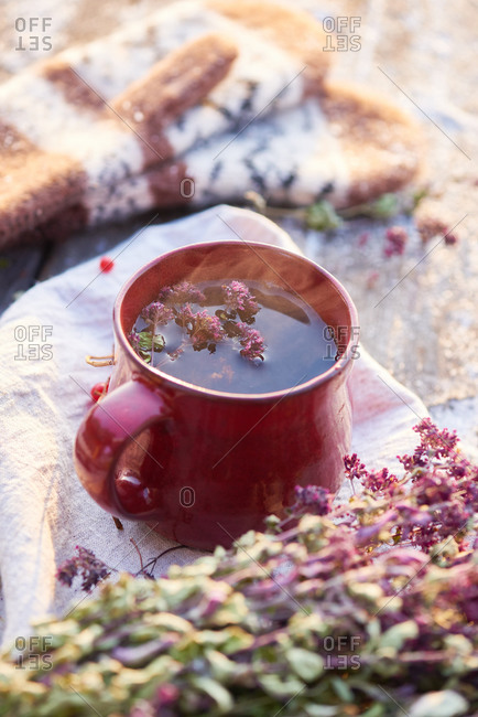 Floral tea steeping in a red mug