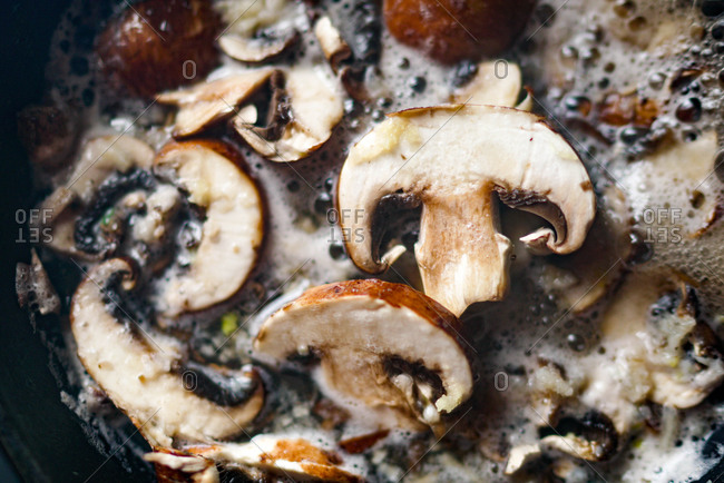 Fresh mushrooms and garlic sauteing in pan