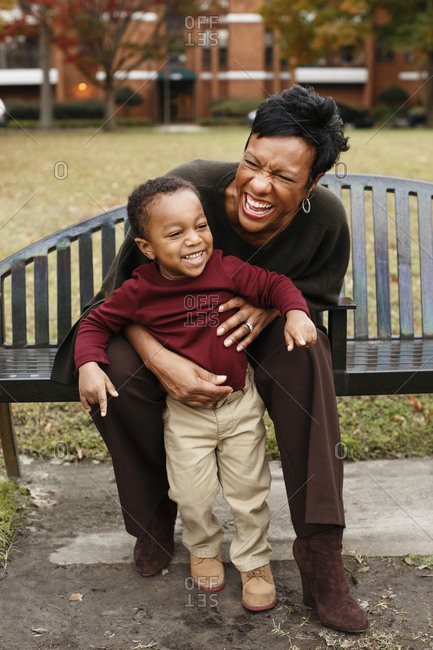 Mother and son playing on park bench