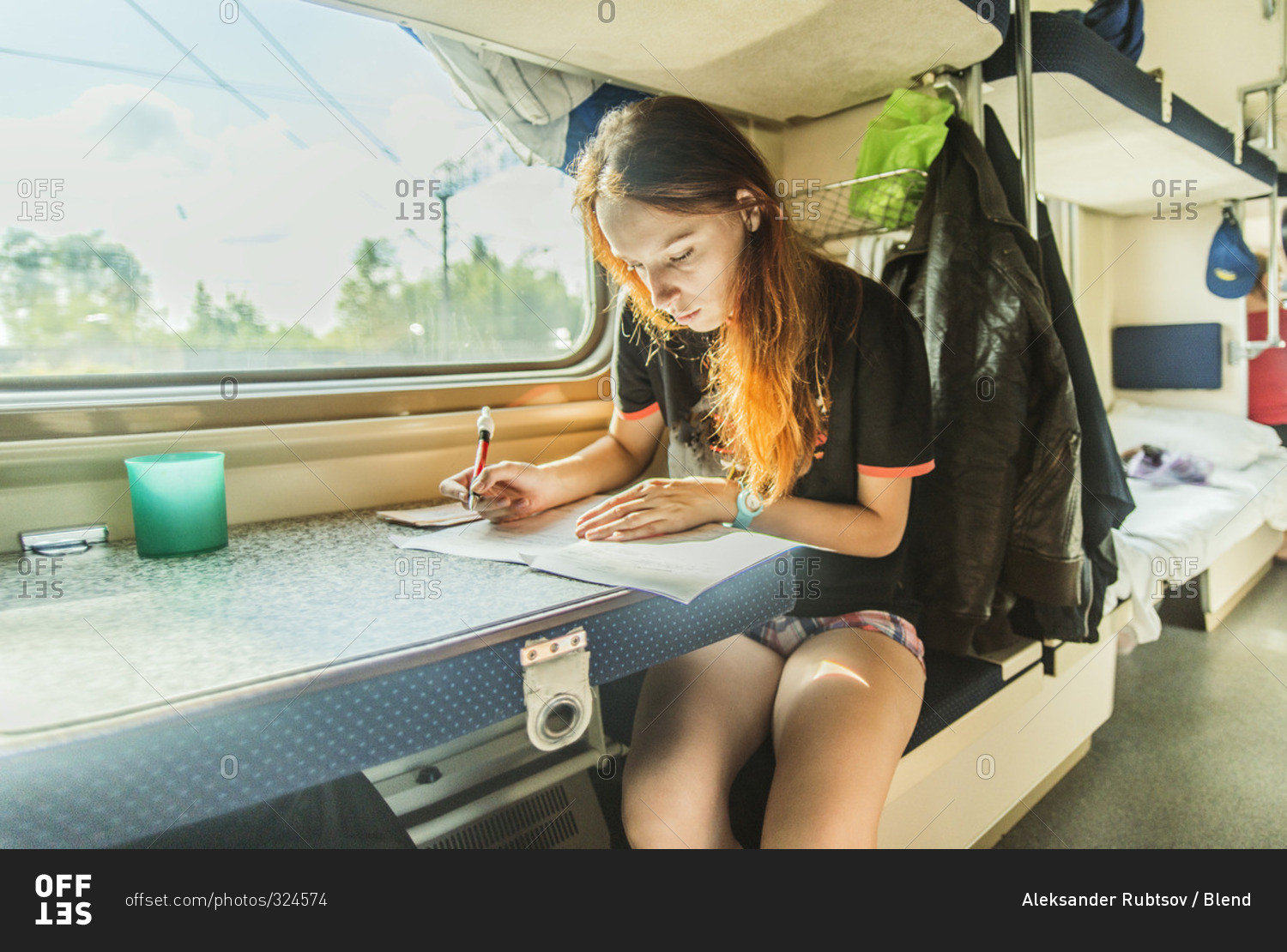 Girl writing on train